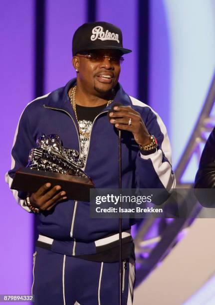 Ronnie DeVoe accepts the Soul Train Certified Award from Deon Cole onstage at the 2017 Soul Train Awards, presented by BET, at the Orleans Arena on...