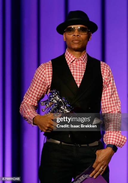 Ricky Bell accepts the Soul Train Certified Award from Deon Cole onstage at the 2017 Soul Train Awards, presented by BET, at the Orleans Arena on...