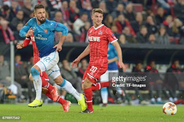 Olivier Giroud of Arsenal and Salih Oezcan of Cologne battle for the ball during the UEFA Europa League Group H soccer match between 1.FC Cologne and...