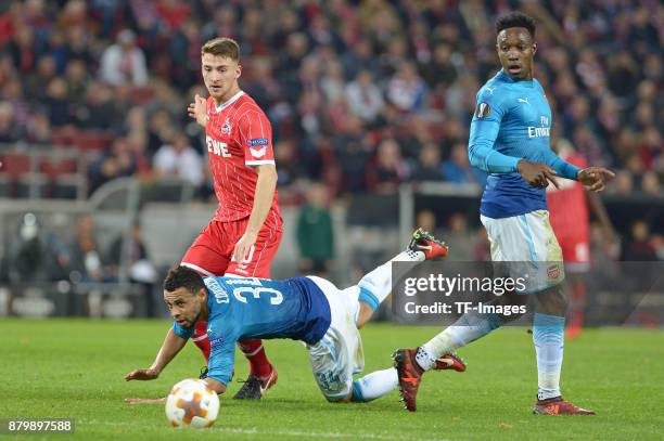 Salih Oezcan of Cologne and Francis Coquelin of Arsenal and Danny Welbeck of Arsenal battle for the ball during the UEFA Europa League Group H soccer...
