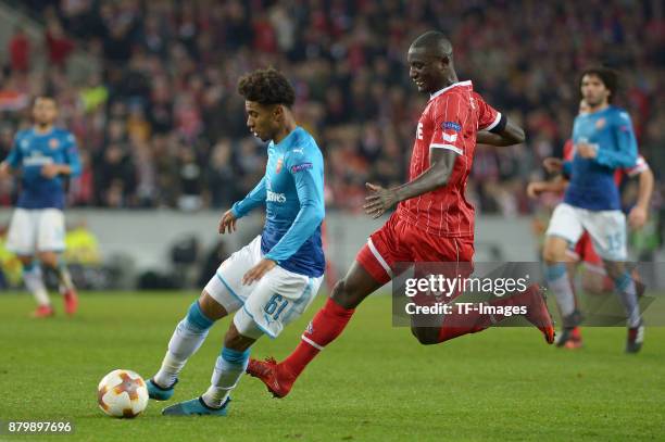 Reiss Nelson of Arsenal and Sehrou Guirassy of Cologne battle for the ball during the UEFA Europa League Group H soccer match between 1.FC Cologne...