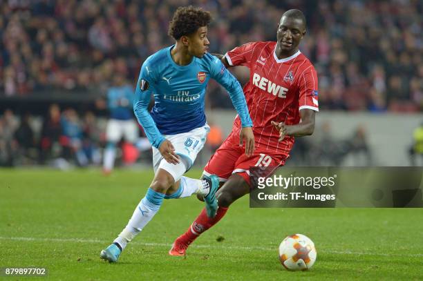 Reiss Nelson of Arsenal and Sehrou Guirassy of Cologne battle for the ball during the UEFA Europa League Group H soccer match between 1.FC Cologne...