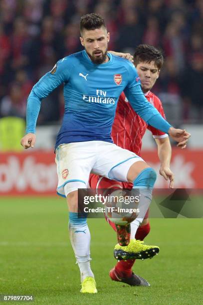 Olivier Giroud of Arsenal and Jorge Mere of Cologne battle for the ball during the UEFA Europa League Group H soccer match between 1.FC Cologne and...