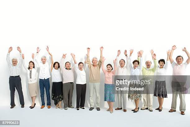 mature and senior people raising arms, portrait - arms raised ストックフォトと画像