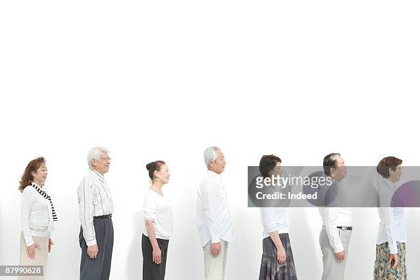 profiles of senior men and women standing in a raw - senior woman studio ストックフォトと画像