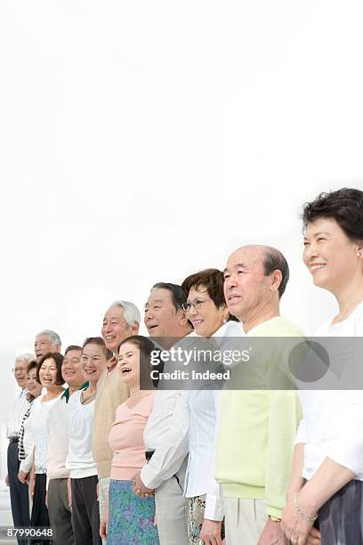 group of japanese people standing in a row - 人の列 ストックフォトと画像