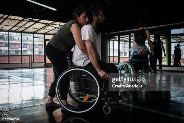 Dancers help each other during a performance training at the ConCuerpos Gym in Bogota, Colombia on November 25, 2017. ConCuerpos Dance Company has...
