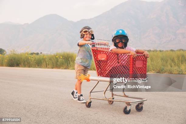 young boy shopping cart racing team - helmet cart stock pictures, royalty-free photos & images