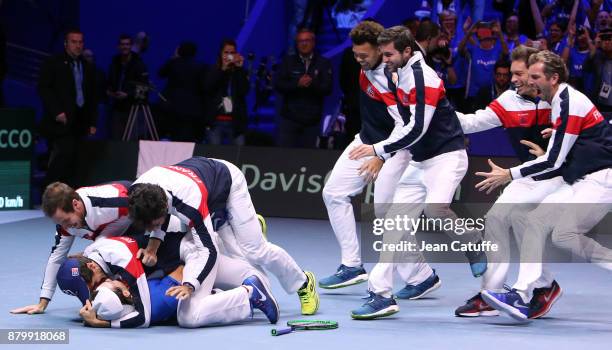 Members of team France celebrate winning the Davis Cup when Lucas Pouille of France beats Steve Darcis of Belgium in the 5th match during day 3 of...