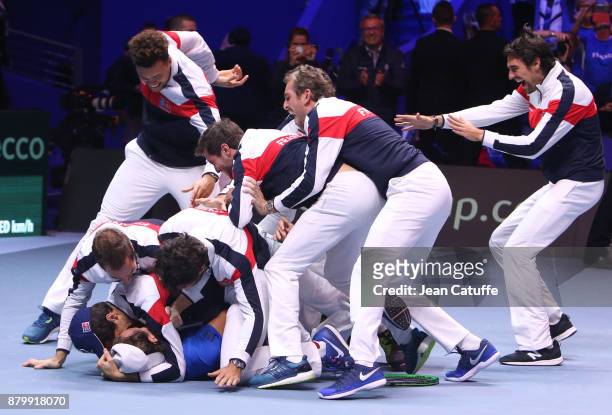 Members of team France celebrate winning the Davis Cup when Lucas Pouille of France beats Steve Darcis of Belgium in the 5th match during day 3 of...