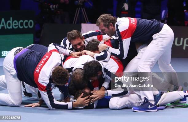 Members of team France celebrate winning the Davis Cup when Lucas Pouille of France beats Steve Darcis of Belgium in the 5th match during day 3 of...