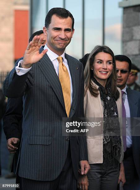 Spain's Crown Prince Felipe de Borbon waves next to his wife princess Letizia Ortiz upon arrival at the CATAM military base in Bogota, Colombia, on...