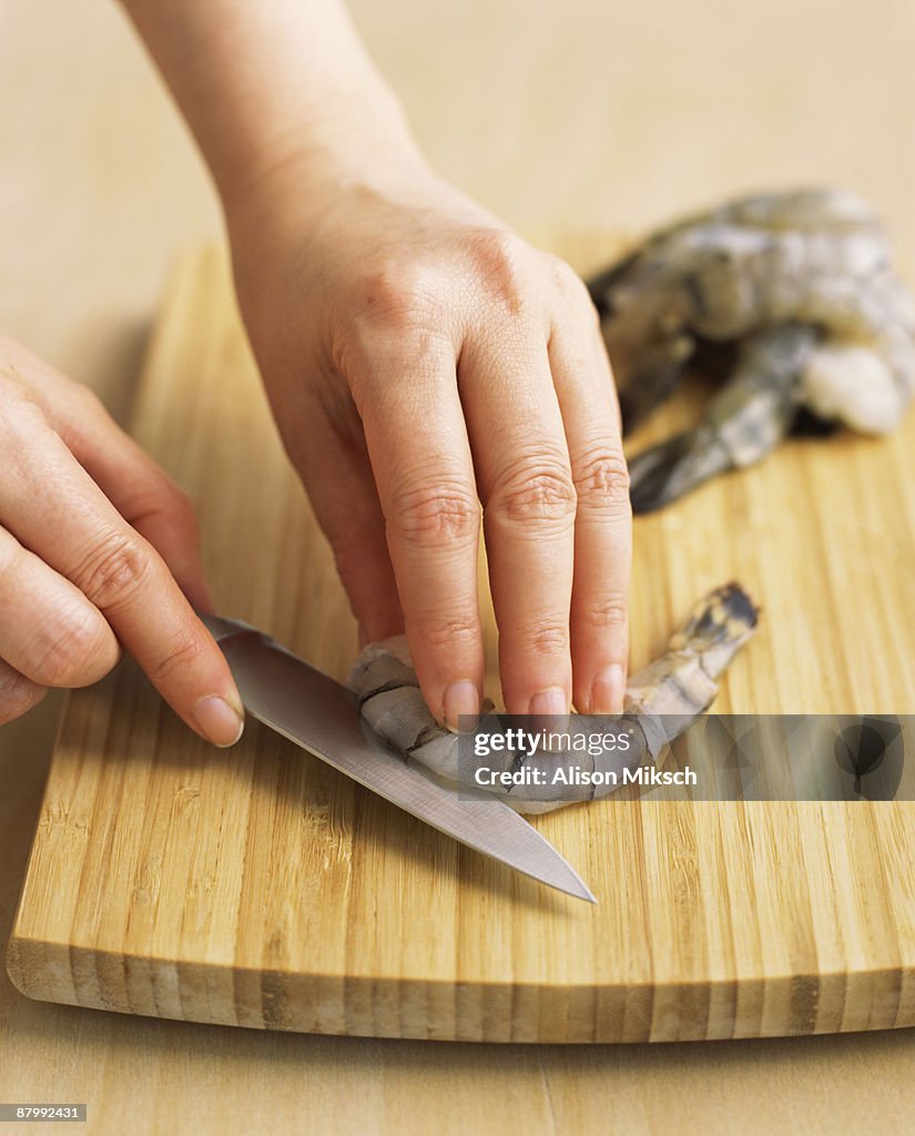 Hands de-veining shrimp