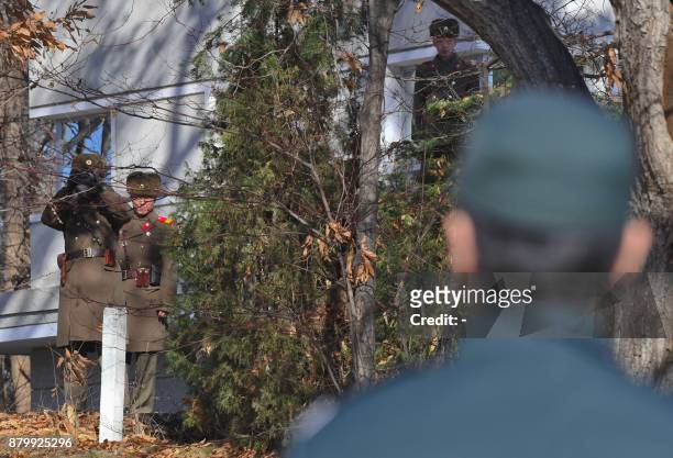North Korean soldiers stare at South Korean soldiers at the truce village of Panmunjom in the Demilitarized zone dividing the two Koreas on November...