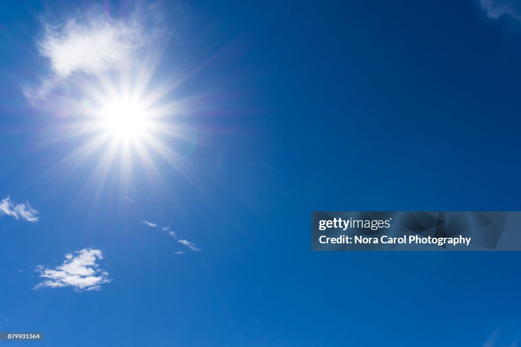 Blue Sky and Clouds with Sunburst