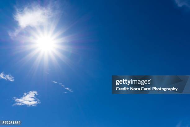 blue sky and clouds with sunburst - midday stock pictures, royalty-free photos & images