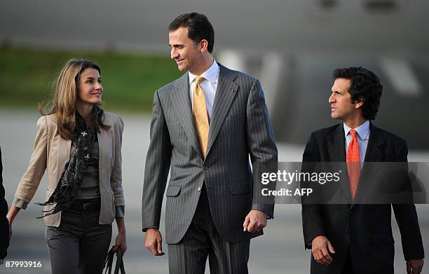 Spain's Crown Prince Felipe de Borbon and his wife princess Letizia Ortiz walk next to Colombian Foreign Minister Jaime Bermudez upon arrival at the...