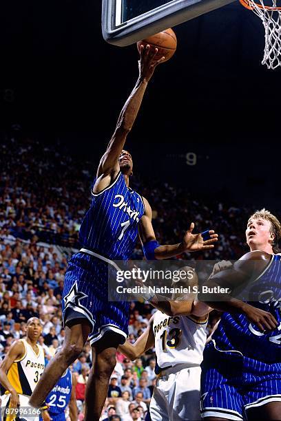 Anfernee Hardaway of the Orlando Magic shoots a layup against Rick Smits of the Indiana Pacers in Game Four of the Eastern Conference Finals during...