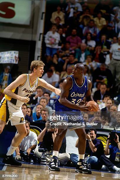 Shaquille O'Neal of the Orlando Magic posts up against Rick Smits of the Indiana Pacers in Game Four of the Eastern Conference Finals during the 1995...