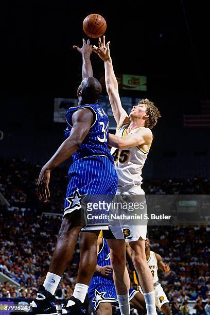 Rick Smits of the Indiana Pacers goes up for a shot Shaquille O'Neal of the Orlando Magic in Game Four of the Eastern Conference Finals as part of...