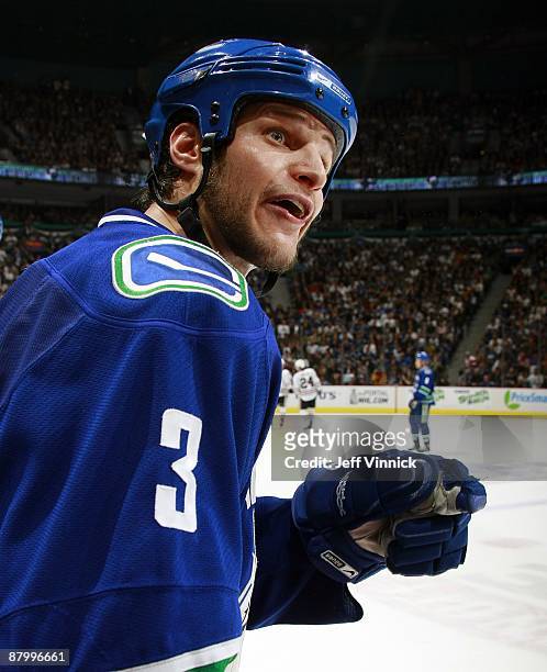 Kevin Bieksa of the Vancouver Canucks looks on from the bench during Game Five of the Western Conference Semifinal Round of the 2009 Stanley Cup...