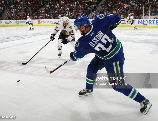 Daniel Sedin of the Vancouver Canucks shoots the puck past Martin Havlat of the Chicago Blackhawks during Game Five of the Western Conference...