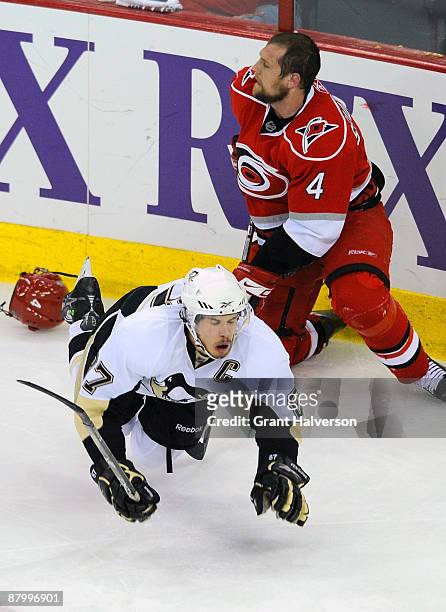 Dennis Seidenberg of the Carolina Hurricanes trips Sidney Crosby of the Pittsburgh Penguins during Game Four of the Eastern Conference Championship...