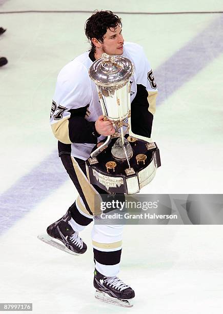 Sidney Crosby of the Pittsburgh Penguins skates off the ice with the Prince of Wales trophy after defeating the Carolina Hurricanes 4-1 in Game Four...