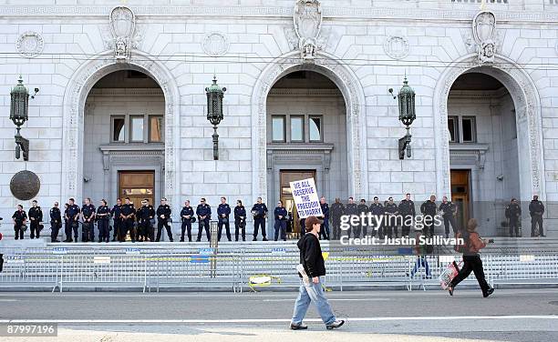 Supporter of same-sex marriage walks by the California Supreme Court following its ruling to uphold Proposition 8 May 26, 2009 in San Francisco,...