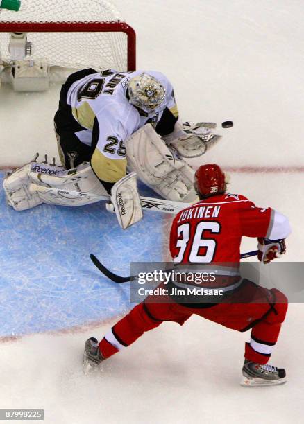 Goaltender Marc-Andre Fleury of the Pittsburgh Penguins saves a shot on goal by Jussi Jokinen of the Carolina Hurricanes during Game Four of the...