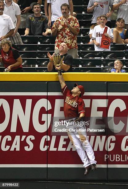 Outfielder Gerardo Parra of the Arizona Diamondbacks attempts to catch a solo home run hit by Chris Burke of the San Diego Padres during the major...