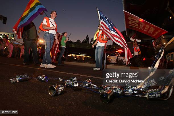 In the tradition of American weddings, a string of cans is dragged behind a march support truck as thousands of supporters of same-sex marriage march...