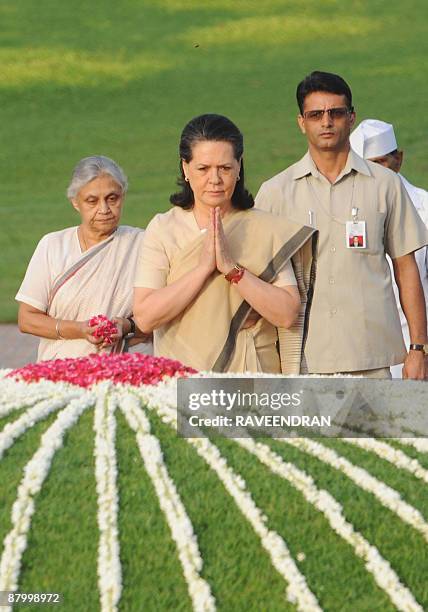 Delhi Chief Minister Sheila Dixit and India's Congress Party President Sonia Gandhi pay tribute during a memorial ceremony for post-independence...
