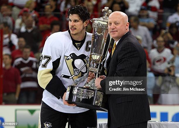 Sidney Crosby of the Pittsburgh Penguins accepts the Prince of Wales trophy from Deputy Commissioner of the NHL Bill Daly after their 4-1 win over...