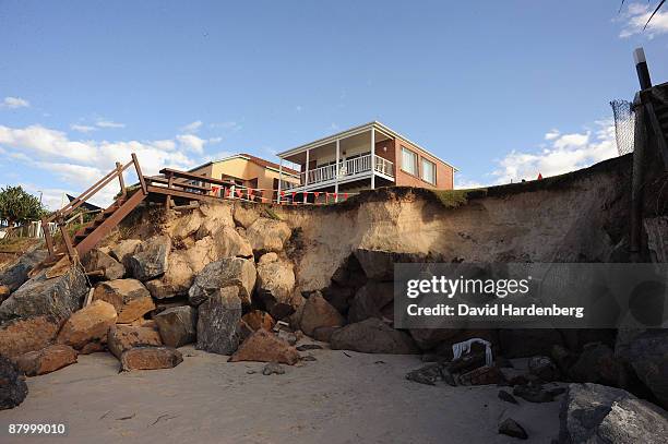 Million dollar beachside homes on Queensland's Palm Beach teeter on the edge of sand dunes following erosion from the recent king tides, at Palm...