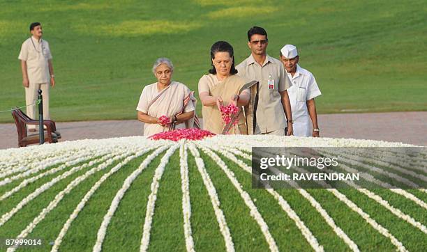 Delhi Chief Minister Sheila Dixit and India's Congress Party President Sonia Gandhi pay tribute during a memorial ceremony for post-independence...