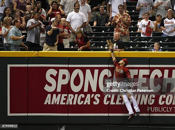 Outfielder Gerardo Parra of the Arizona Diamondbacks attempts to catch a solo home run hit by Chris Burke of the San Diego Padres during the eighth...