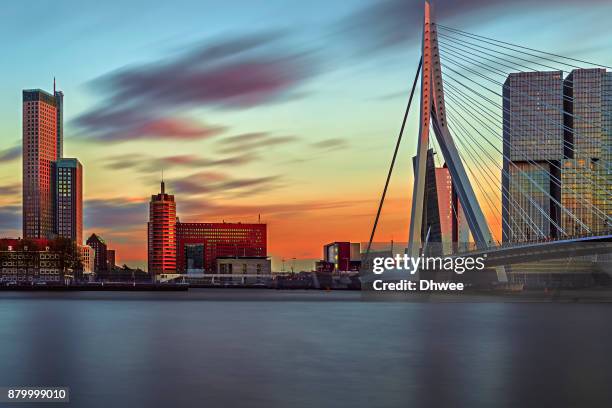 long exposure of rotterdam skylines and new meuse river during sunset, netherlands - rotterdam bridge stock pictures, royalty-free photos & images