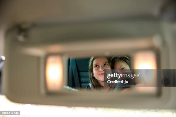 girls in rear-view mirror - rear view mirror stock pictures, royalty-free photos & images