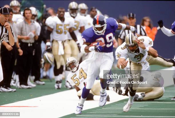 Amani Toomer of the New York Giants returns a punt against the New Orlean Saints during an NFL football game September 28, 1997 at Giants Stadium in...
