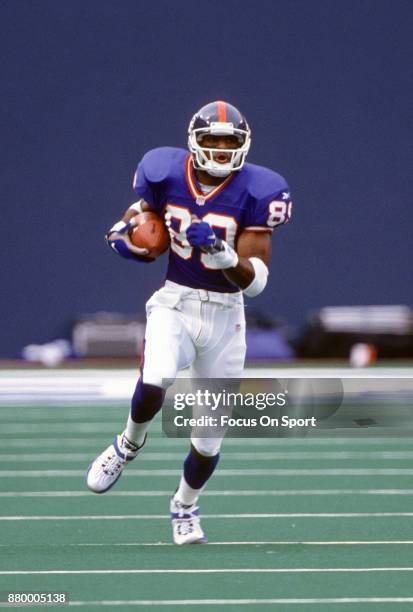 Amani Toomer of the New York Giants returns a punt against the New Orlean Saints during an NFL football game September 28, 1997 at Giants Stadium in...