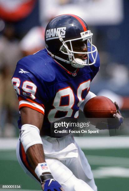 Amani Toomer of the New York Giants returns a punt against the Philadelphia Eagles during an NFL football game August 31, 1997 at Giants Stadium in...