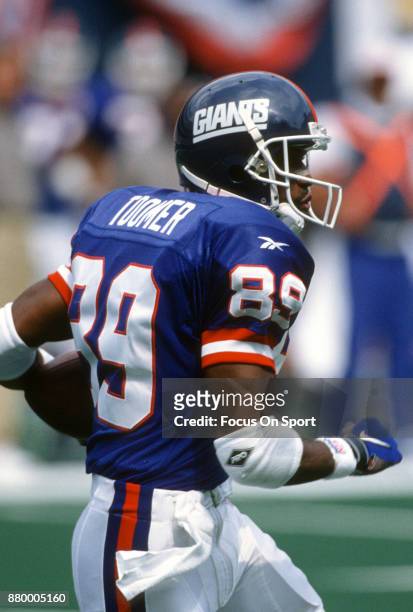 Amani Toomer of the New York Giants returns a punt against the Philadelphia Eagles during an NFL football game August 31, 1997 at Giants Stadium in...