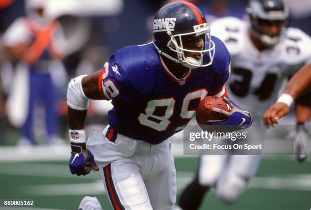 Amani Toomer of the New York Giants returns a punt against the Philadelphia Eagles during an NFL football game August 31, 1997 at Giants Stadium in...