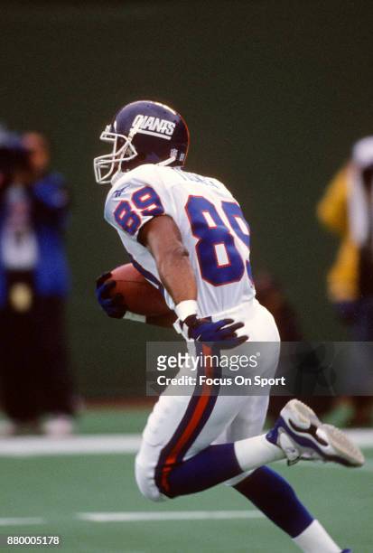 Amani Toomer of the New York Giants returns a punt against the New York Jets during an NFL football game September 22, 1996 at Giants Stadium in East...