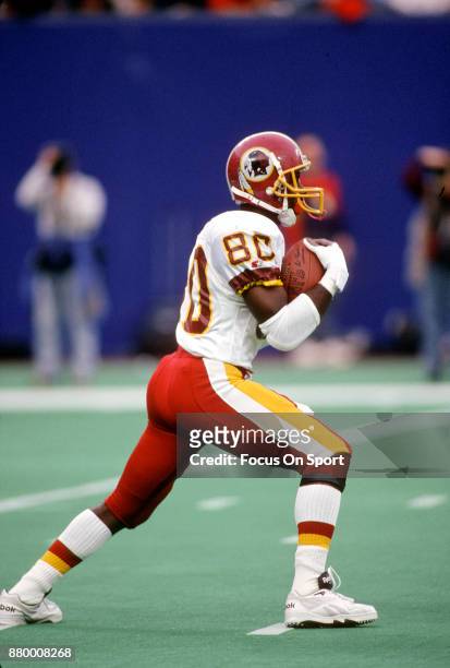 Desmond Howard of the Washington Redskins returns a punt against the New York Giants during an NFL football game December 6, 1992 at Giants Stadium...