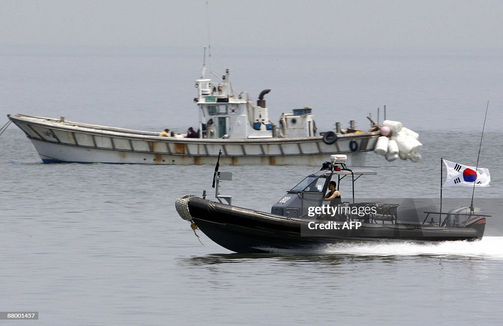 A South Korean military boat (lower) pow