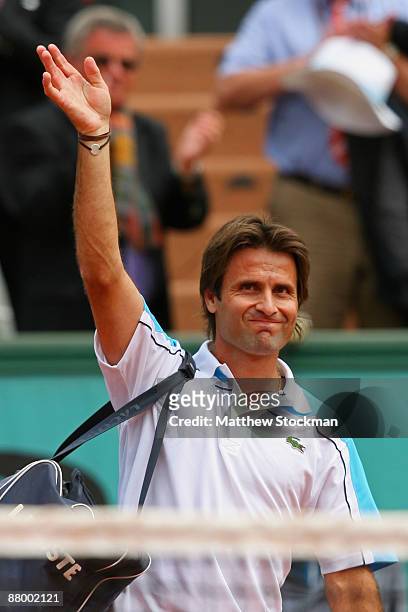 Fabrice Santoro of France acknowledges the crowd following his Men's Singles First Round match against Christophe Rochus of Belgium on day four of...
