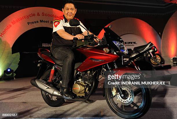 Honda Motorcycle and Scooter India President and CEO Shinji Aoyama poses on a new Honda CBF Stunner PGM-F1 motorbike at a launch function in Mumbai...