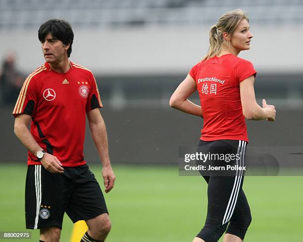 Headcoach Joachim Loew and fencing olympic champion Britta Heidemann attend the German national team training session at the Shanghai Stadium on May...